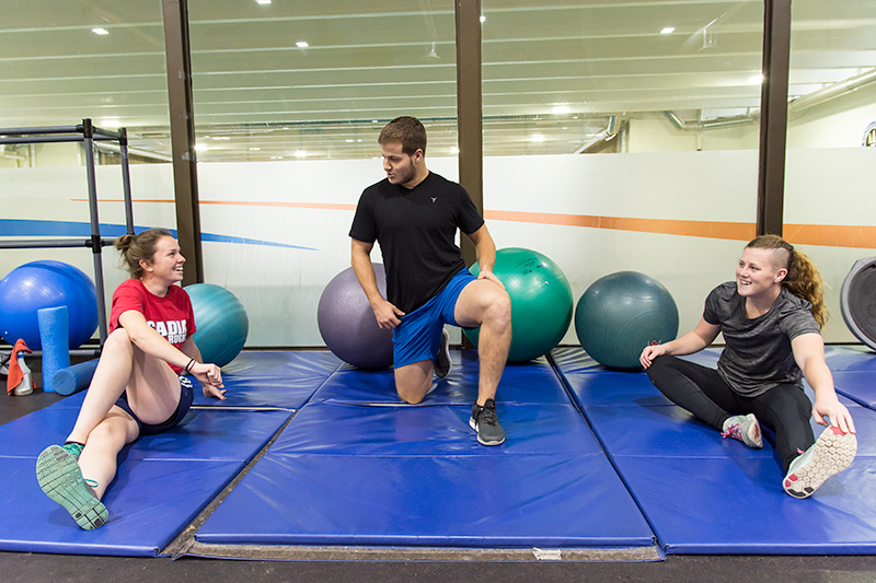 Students stretch in the fitness centre
