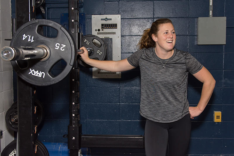A student athlete enjoys the weightlifting area